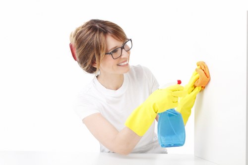 Professional builders cleaning for a renovated room in W1W